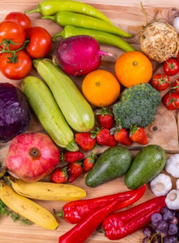 table covered with various fruits and vegetables