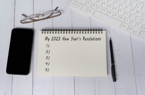 notebook with a list of new year's resolutions on desk