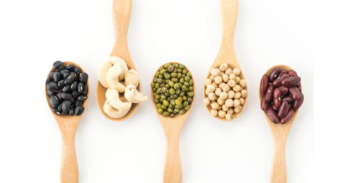 5 spoons filled with various beans