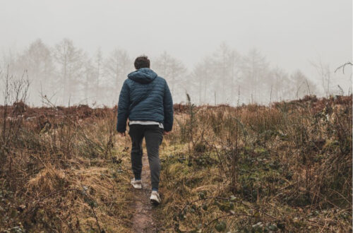 man walking on nature trail
