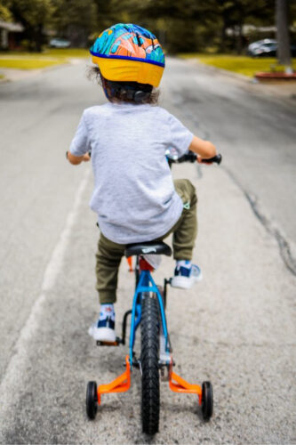 child riding tricycle