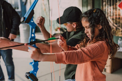 girl learning archery