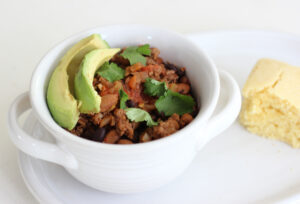 Bowl of chili with avocado and cilantro
