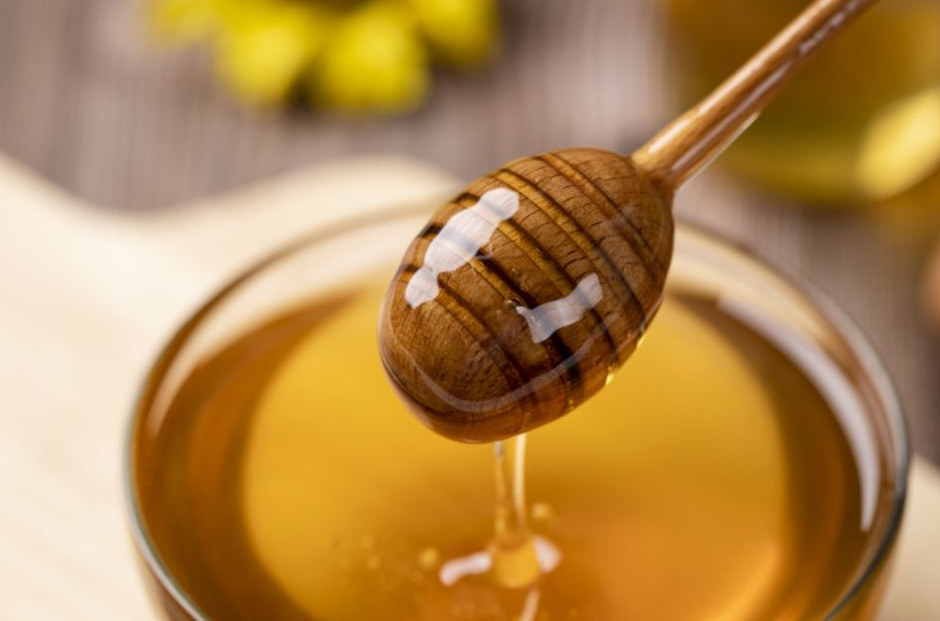 Honey dripping off of honey dipper