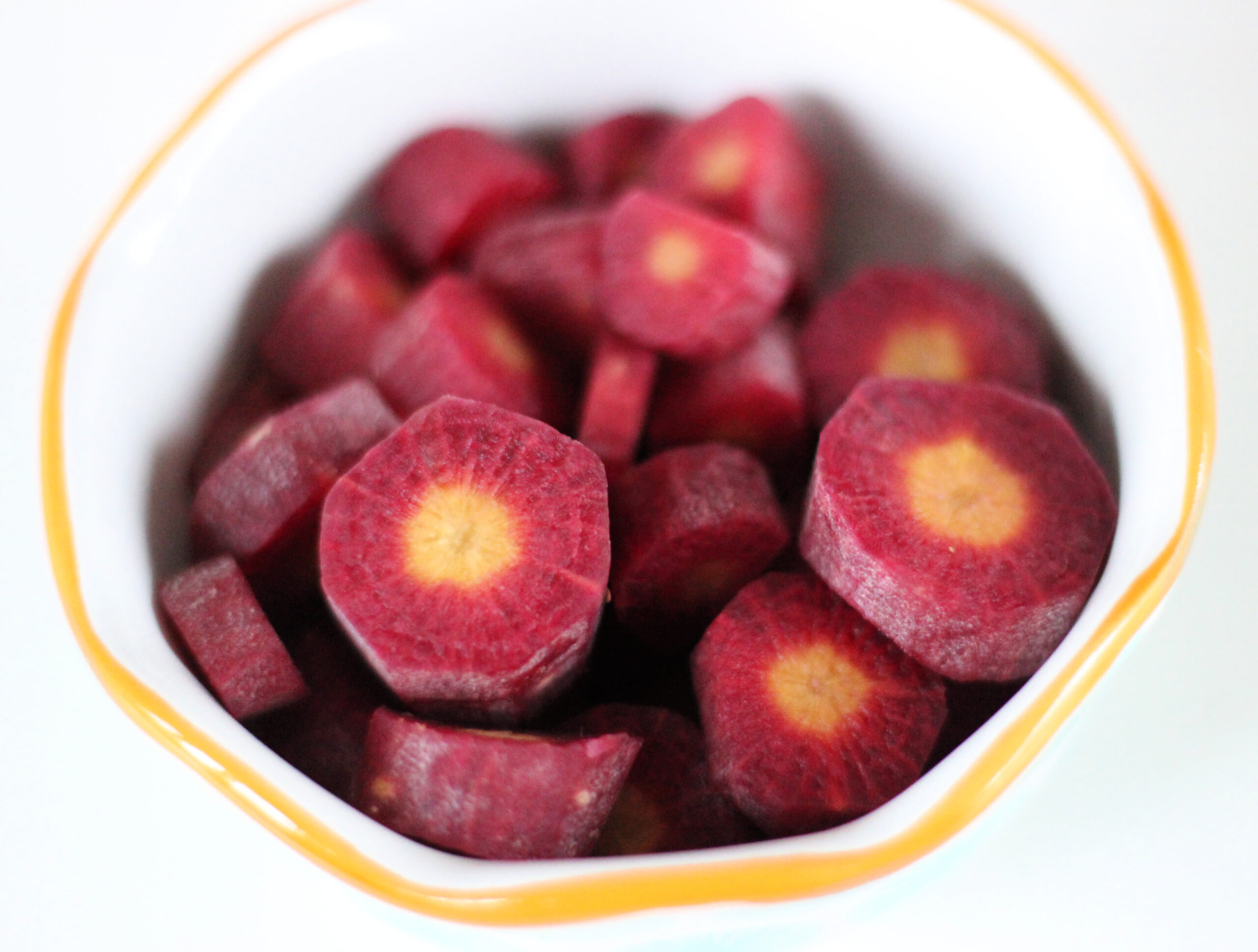 Bowl of sliced purple carrot