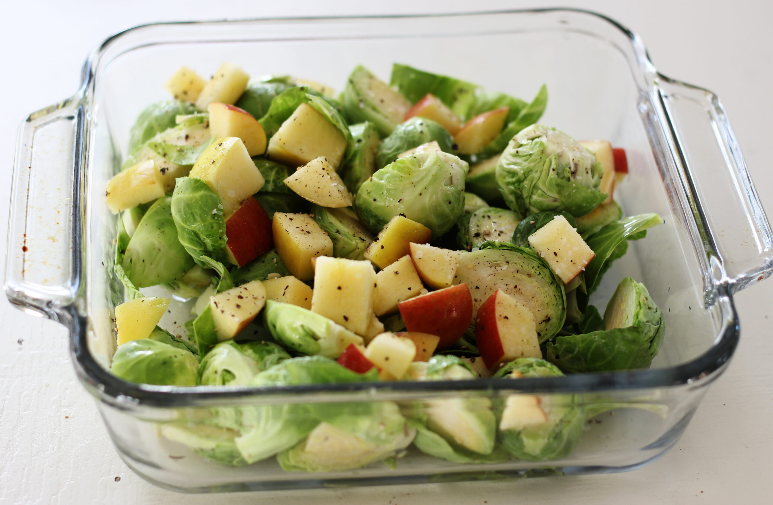 brussels sprouts and apple in a baking dish